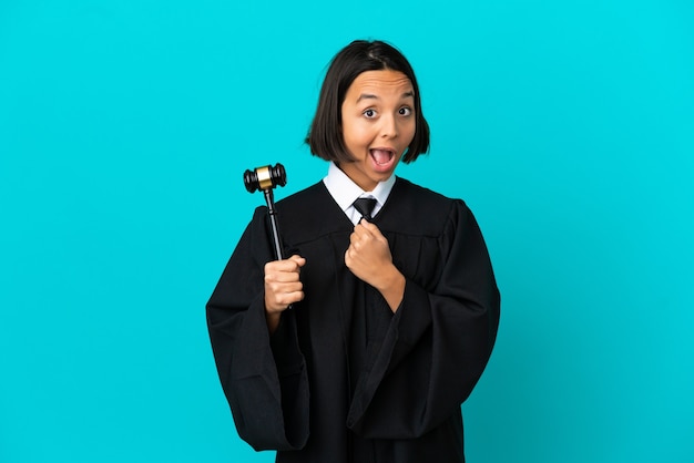 Judge over isolated blue background celebrating a victory