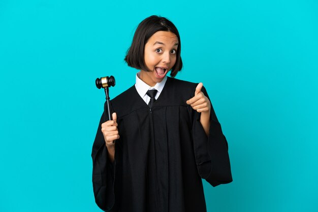 Judge over isolated blue background giving a thumbs up gesture