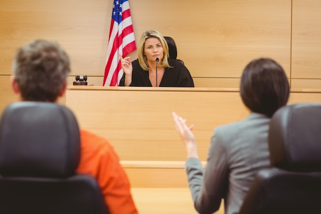 Judge and lawyer discussing the sentence for prisoner