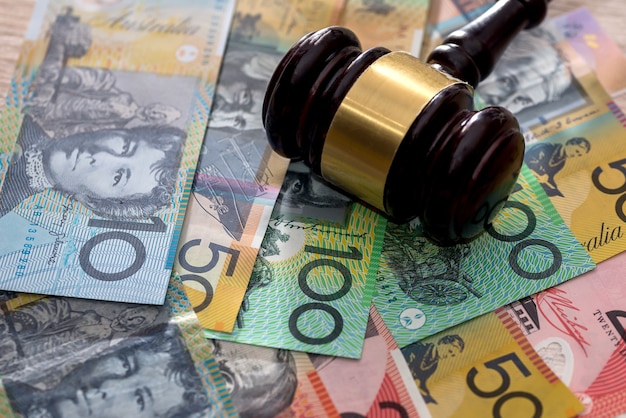 Photo judge's gavel on australian dollars, justice concept