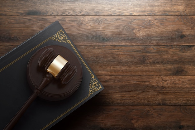 Judge's gavel and book on wooden background