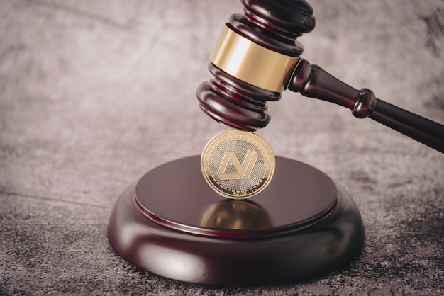 Judge's gavel holding a descriptive cryptocurrency coin.