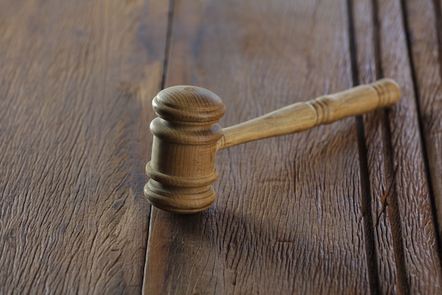 Judge's gavel on old wood table