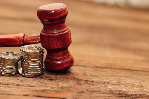 Judge's gavel on the table with Ukrainian hryvnias in coins