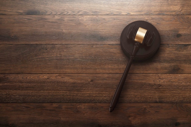 Judge's gavel on wooden background, top view