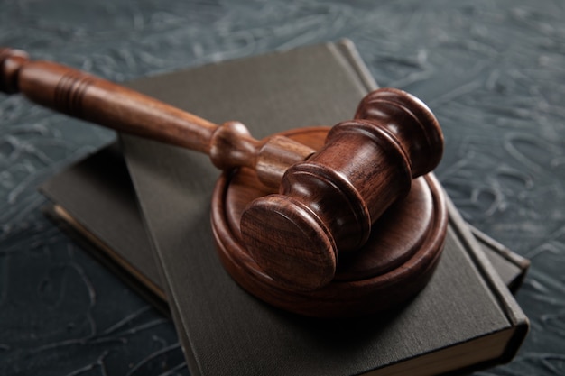 Judge's hammer and legal book on a table