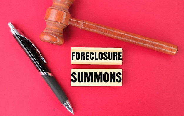 judge's pen and hammer with the word foreclosure summons concept of foreclosure suit