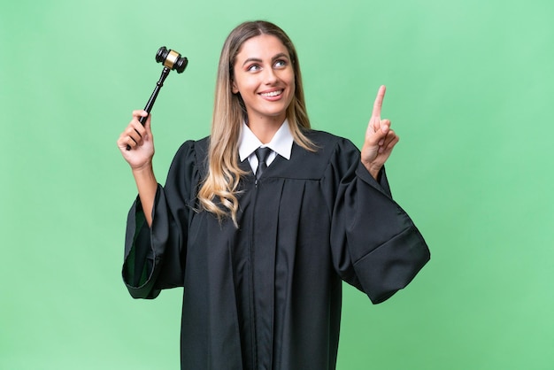 Judge Uruguayan woman over isolated background pointing up a great idea