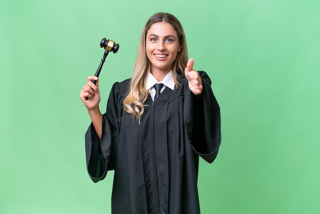 Judge Uruguayan woman over isolated background shaking hands for closing a good deal