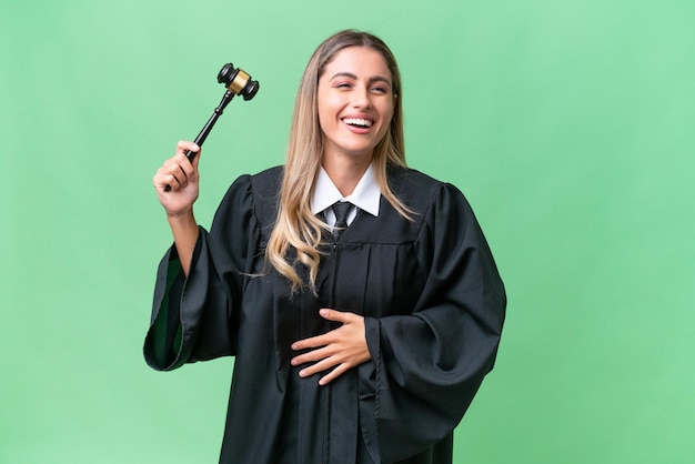 Judge Uruguayan woman over isolated background smiling a lot