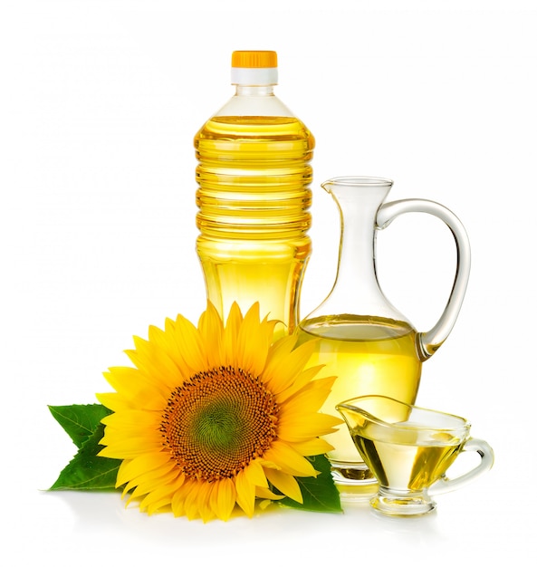 Photo jug and botltle of sunflower oil with flower isolated