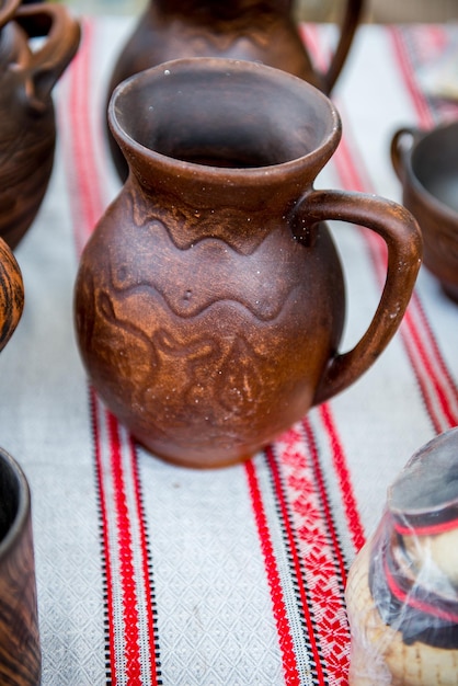 Jug from red clay. Beautiful handmade earthenware jug. Clay handmade jug.