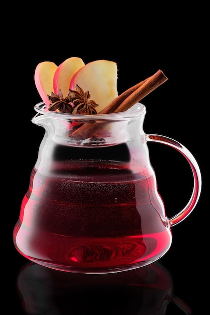 Jug with apple and cranberry tea isolated