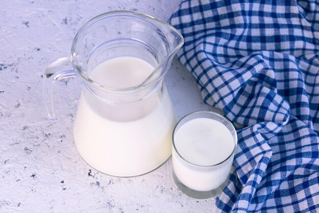 Jug with milk on a white background Top view