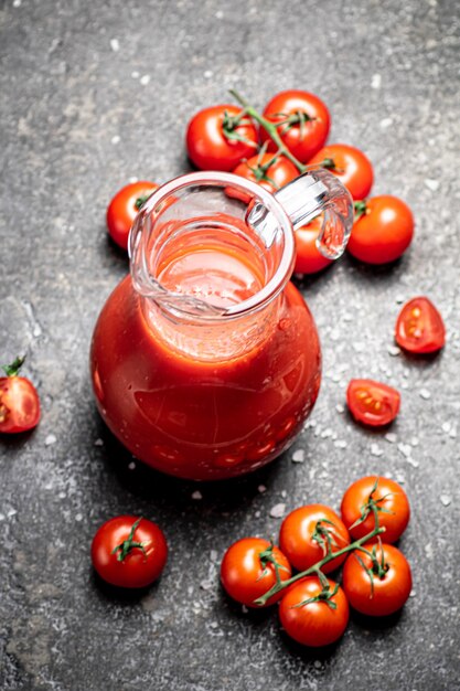 Jug with tomato juice on the table