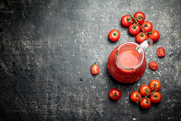 Jug with tomato juice on the table