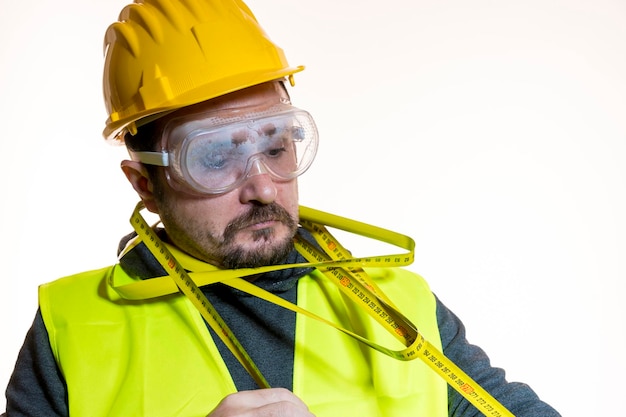 juggling a man who wants to do a work without knowledge, work without experience. Do it yourself, man dressed in yellow builder helmet with protective glasses ready to start the construction work