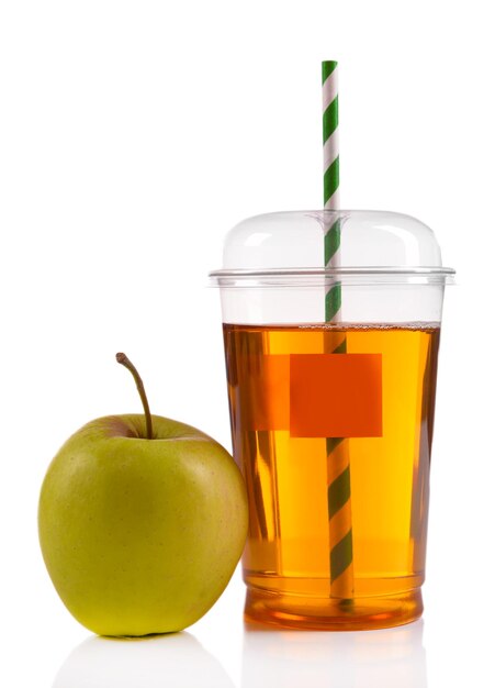 Photo juice in fast food closed cup with tube and apples isolated on white