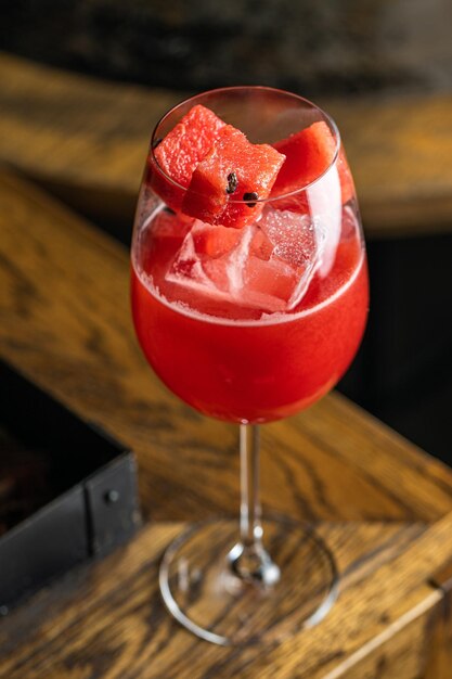 Juice of fresh raspberries served girl holding two cups of red