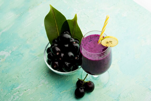 Juice of jamun fruit in a glass also called as java plum, jambolan plum, jambhul, syzygium cumini