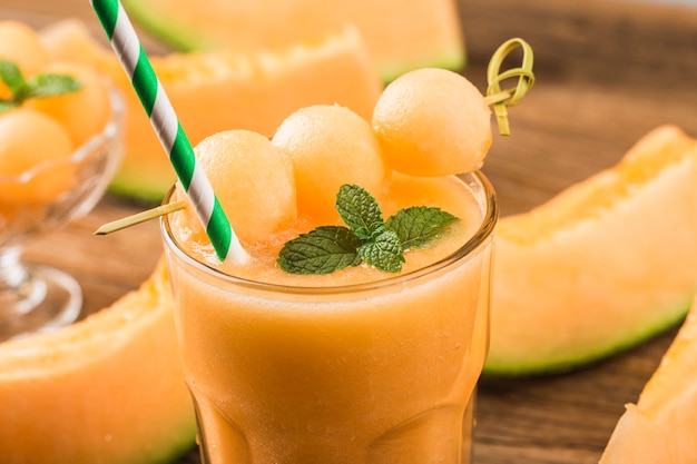 The juice of melon with mint in a glass on the table.Hami melon