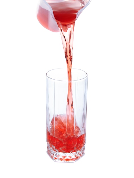 Juice pouring into glass isolated on white