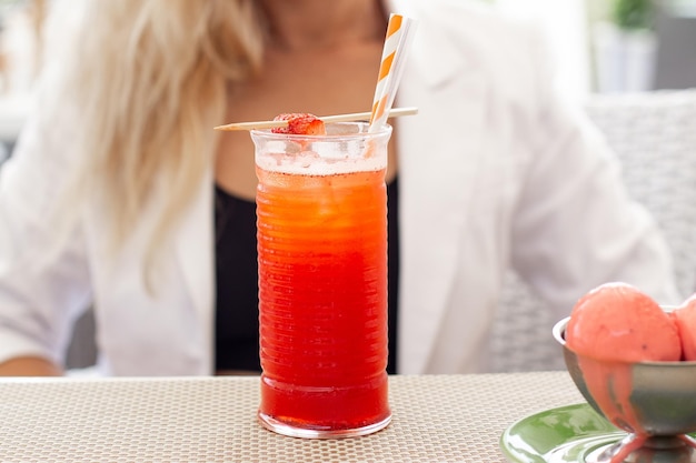 Juice with strawberry on summer restaurant background