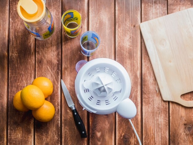 Photo juicer knife and glasses on a wooden table