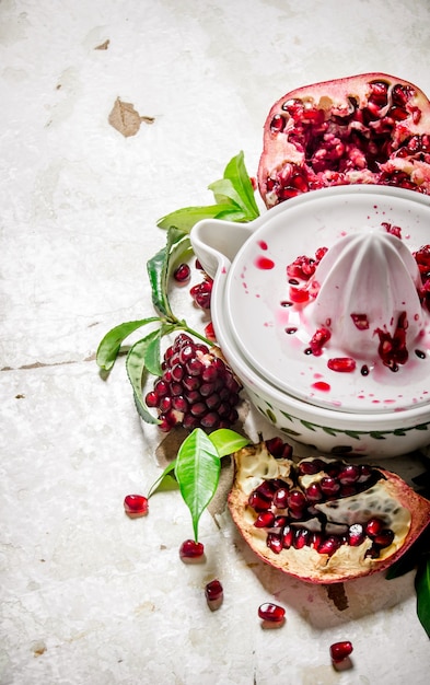 Juicer with bits of pomegranates and leaves