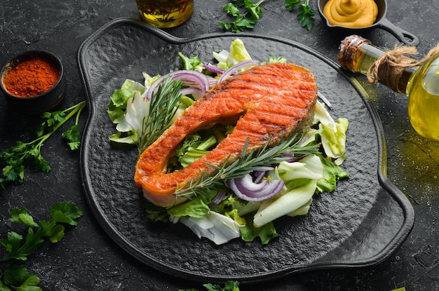 Juicy baked salmon steak with rosemary and spices Top view Barbecue