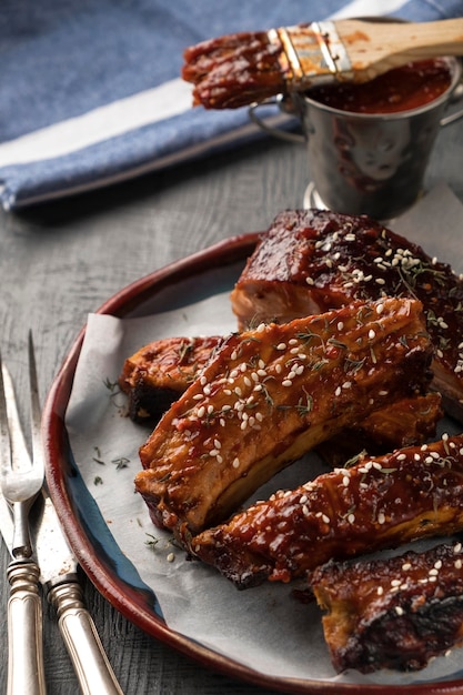 Juicy bbq pork ribs with spicy sauce in a plate