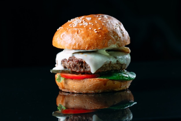 Juicy beef Burger on a black background.