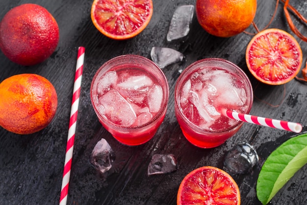 Juicy blood oranges juices with slices or halves