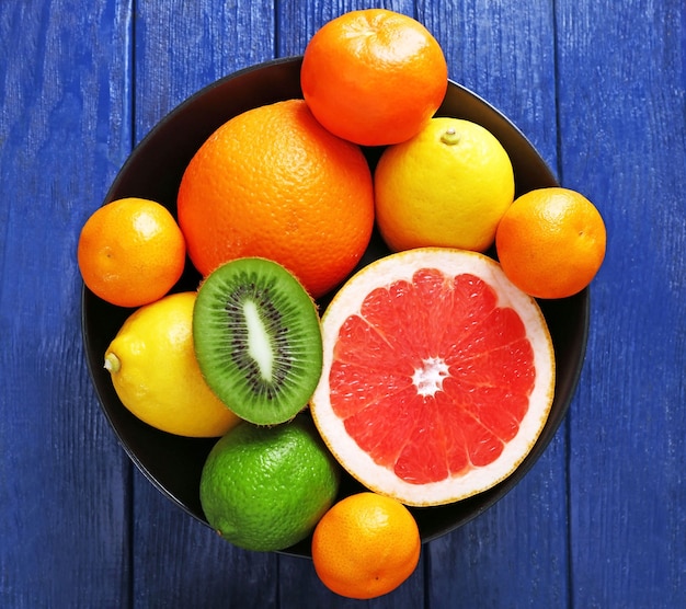 Juicy composition of tropical fruits in a bowl, close up