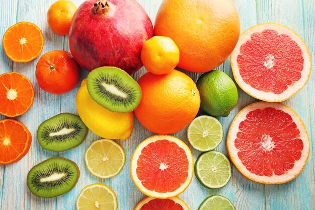 Juicy composition of tropical fruits on wooden background