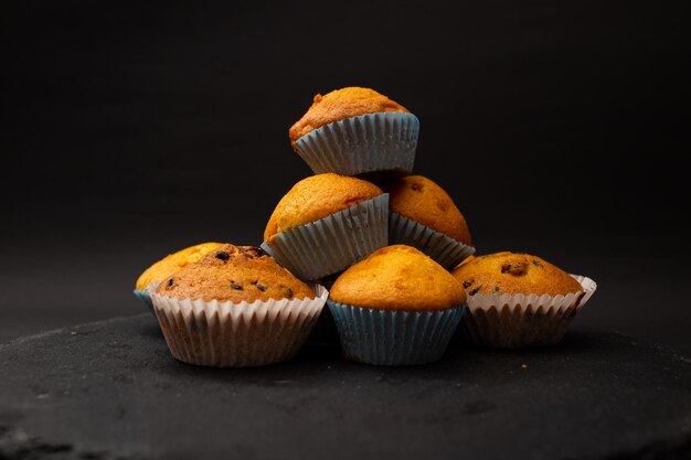 Juicy cupcakes on a black background confectionery bakery