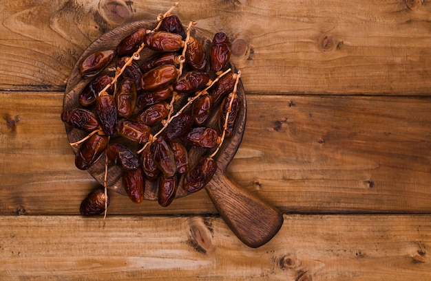 Juicy dates on a wooden table. Dried fruits for a healthy diet. Copy space