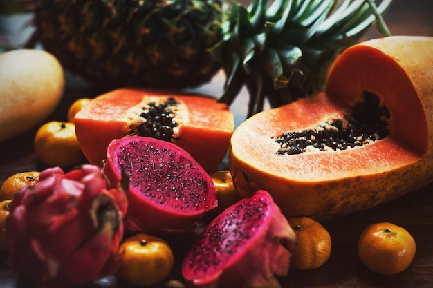 Juicy exotic fruits Pineapple papaya mango gragon fruit on table ready to eat