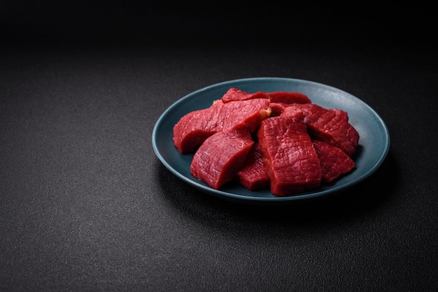 Juicy fresh raw beef meat with salt spices and herbs