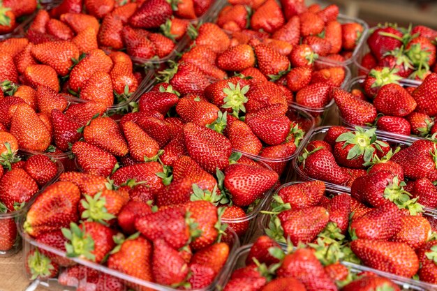 Juicy fresh strawberries at the farmer39s market in plastic containers