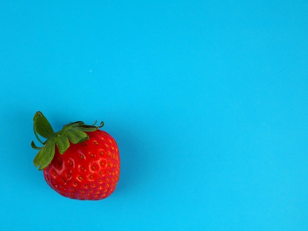 Juicy fresh strawberry on a blue background