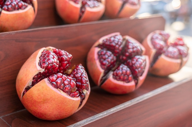 Juicy fruits of ripe pomegranate without peel, berries Shine in the sun. Street trading in Thailand