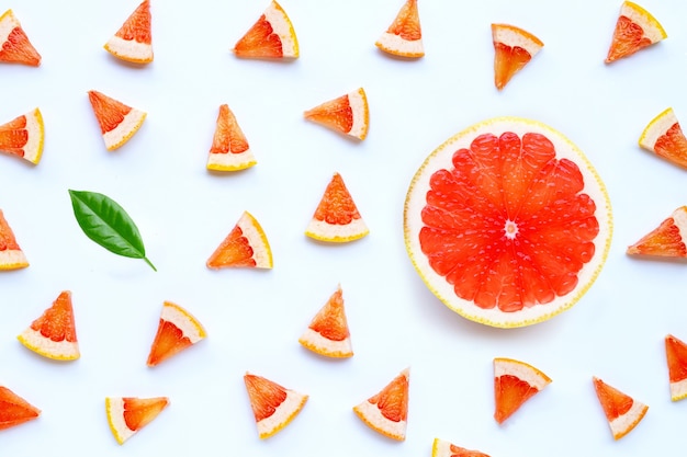Juicy grapefruit slices on white surface