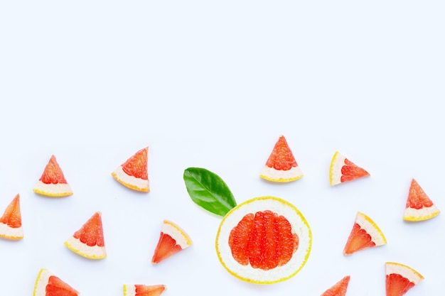 Juicy grapefruit slices on white surface