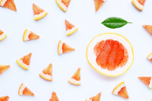 Juicy grapefruit slices on white surface