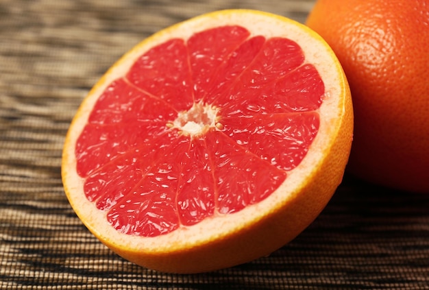 Juicy grapefruits on stripped napkin close up