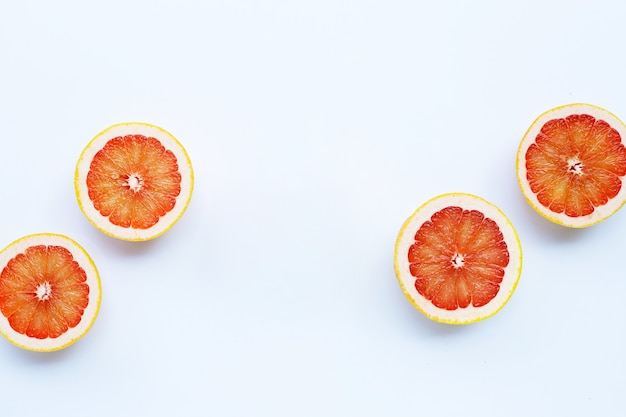 Juicy grapefruits on white surface