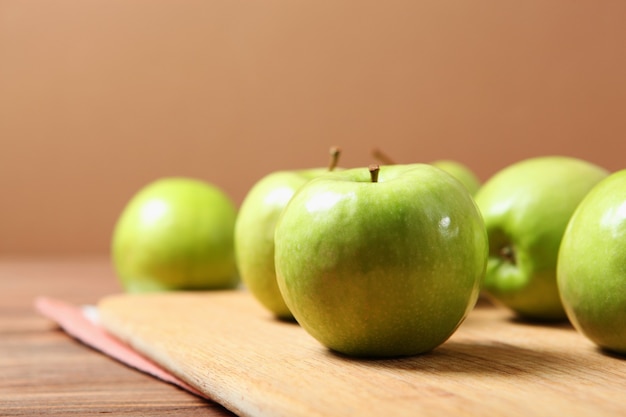 Juicy green apples on a wooden table