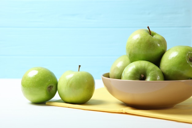 Juicy green apples on a wooden table