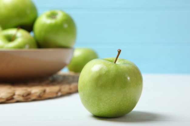 Juicy green apples on a wooden table